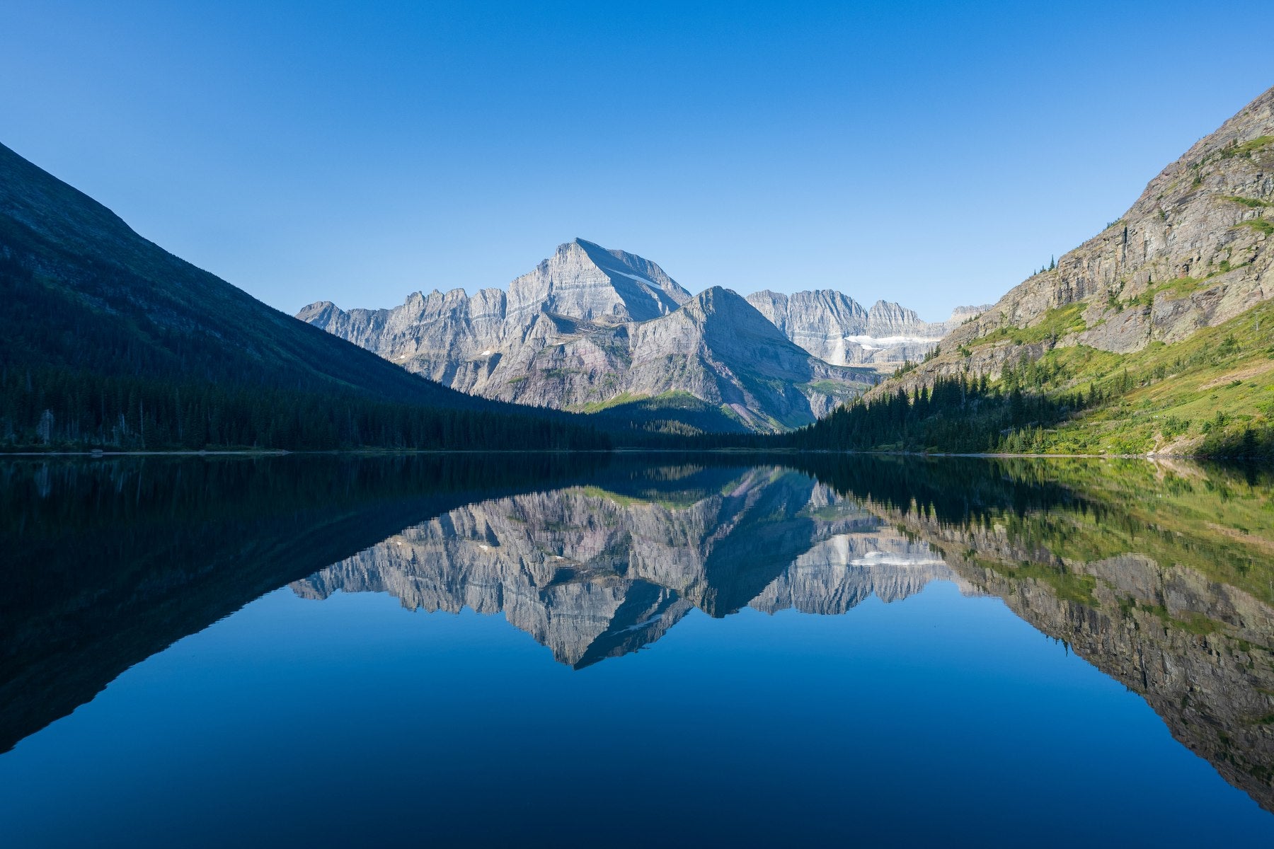 Clear mountain lake with blue water and reflected peaks